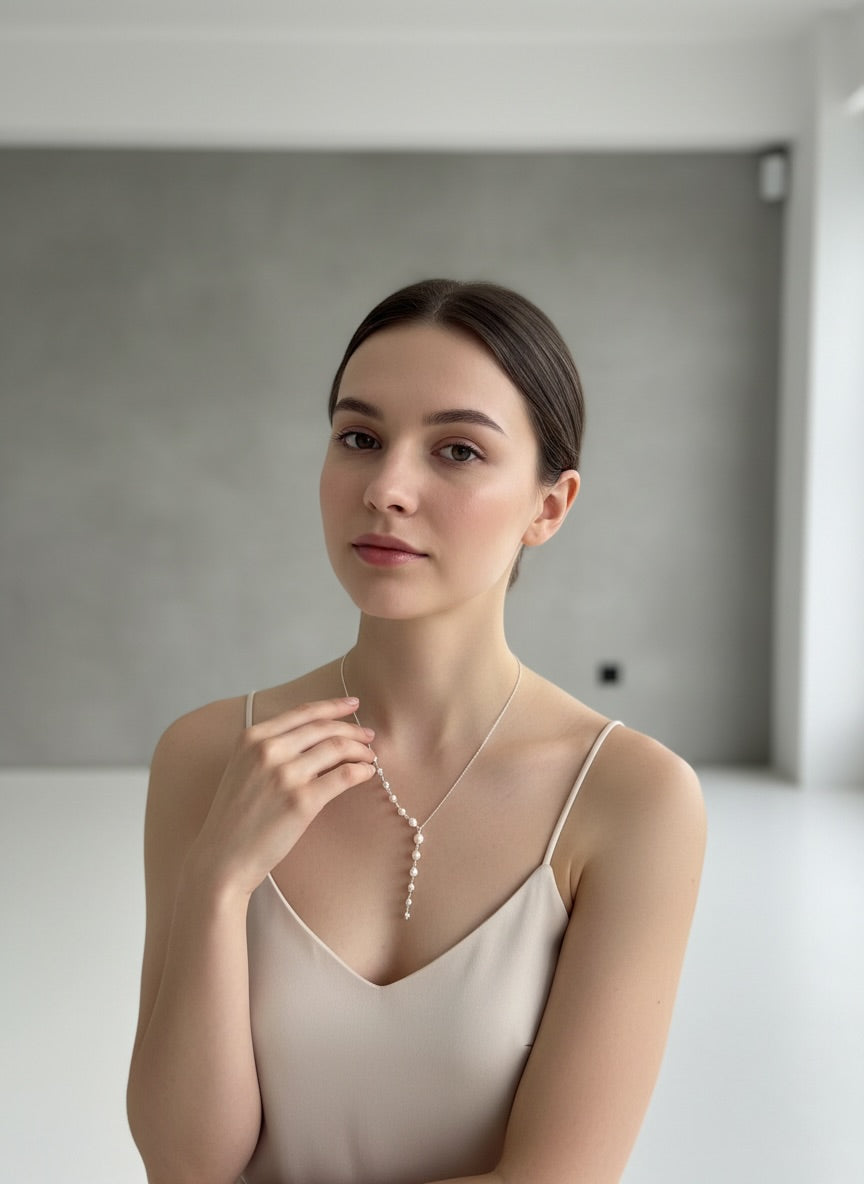 Modern bride wearing a delicate pearl necklace from the Love Letter collection